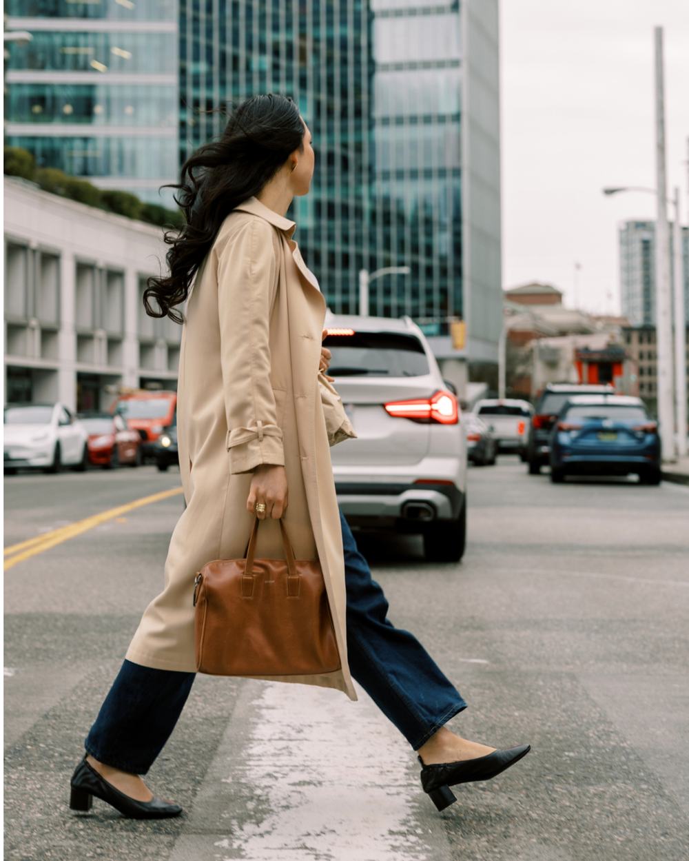 A woman crossing a city street