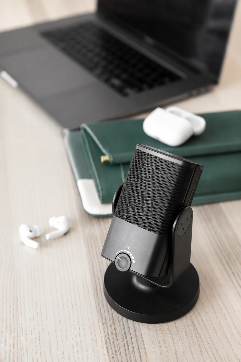 Podcast microphone, notebook and earbuds